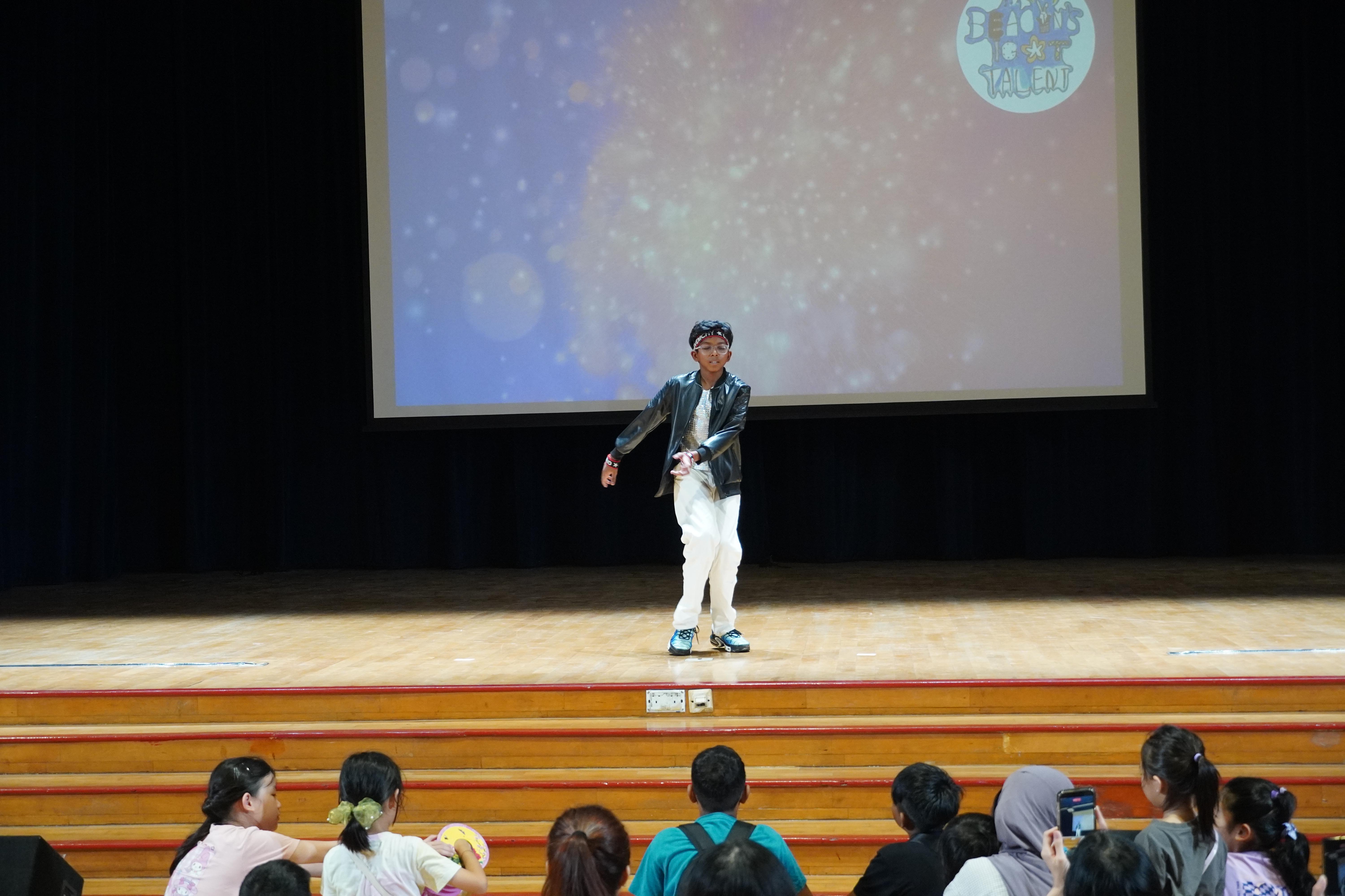 Taking centre stage! With cool moves and plenty of confidence, our  student brings his energy to the stage.